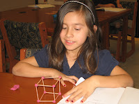 Student showing a cube she made with toothpicks