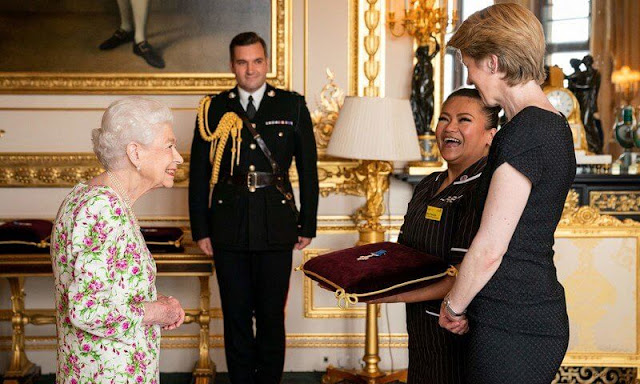The Queen presented the representatives from the National Health Services. Elizabeth wore a floral print dress