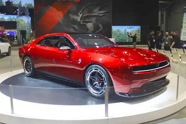 A red Dodge Charger Daytona SRT concept muscle car.