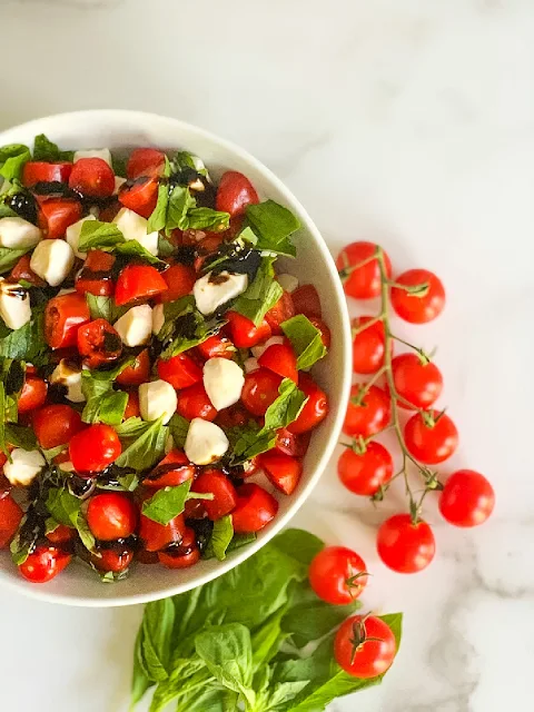 My Easy Chopped Cherry Caprese Salad is loaded with ripe cherry tomatoes, fresh basil, and fresh mozzarella pearls and drizzled with a balsamic glaze.