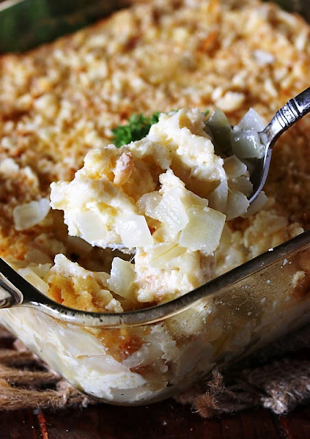 Serving Spoon of Cheesy Sweet Onion Casserole Image