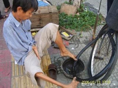 Repairing a punctured bicycle tire with one's feet