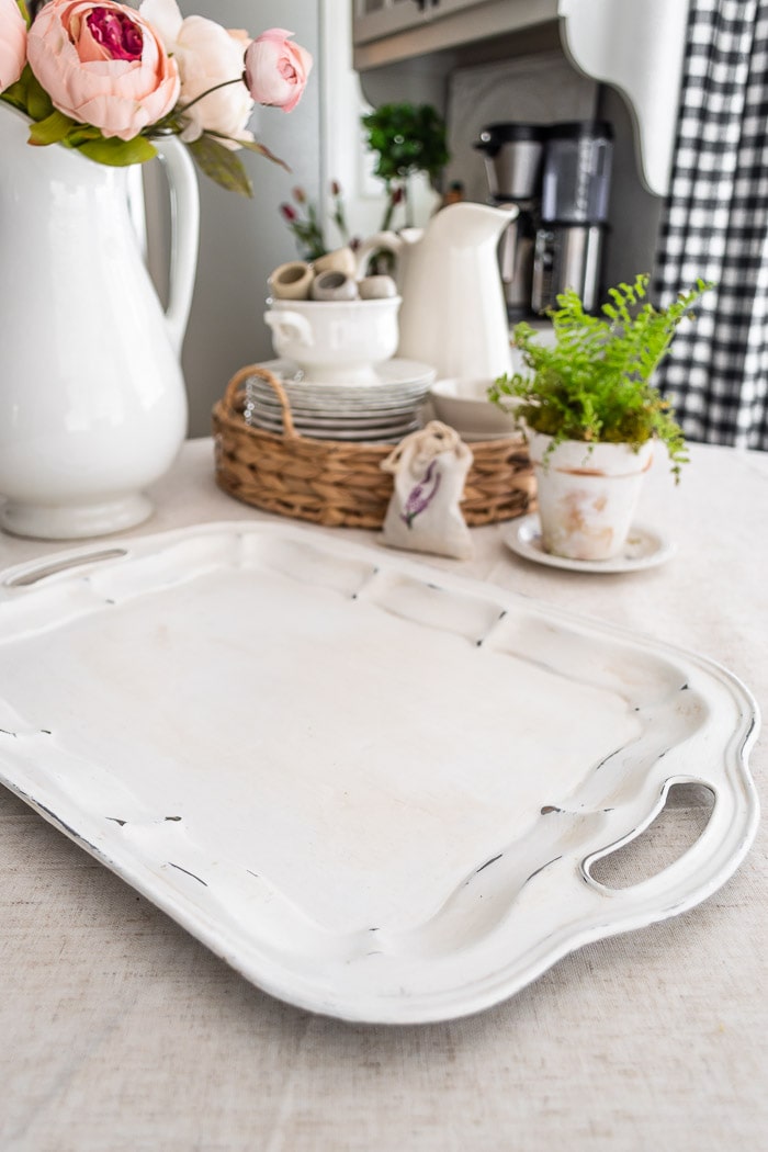 close up of white painted tray shows the light distressing