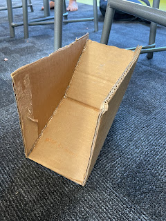 This is a photo of my marble ramp. I think this is a really good marble ramp because of how it was created and presented. We needed cardboard, scissors, hot glue and a marble.