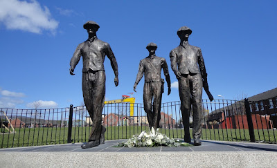 Floral tribute to lives lost on the Titanic (and during its construction) left under the Yardmen sculpture on the Lower Newtownards Road