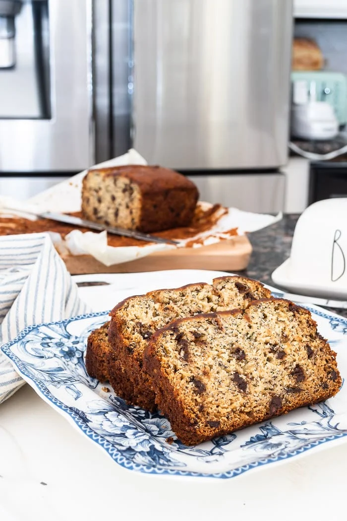 classic banana bread slices studded with mini chocolate chips, blue and white plate