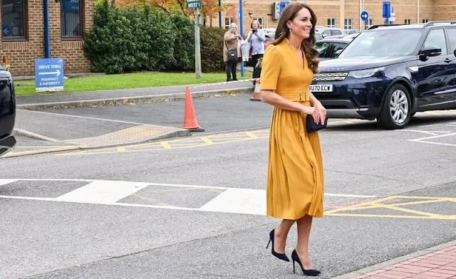 The Princess of Wales wore a pleated belted mustard yellow midi dress by Karen Millen. Kiki citrine diamond earrings
