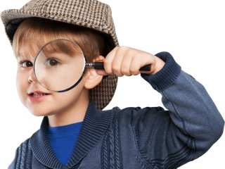 A boy pretend playing to be a detective wearing a brown hat and seeing through a magnifying glass.