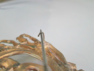 Antique C wire closure on a brooch.