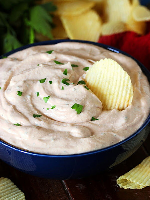 Potato Chip in a Bowl of BBQ Chip Dip Image