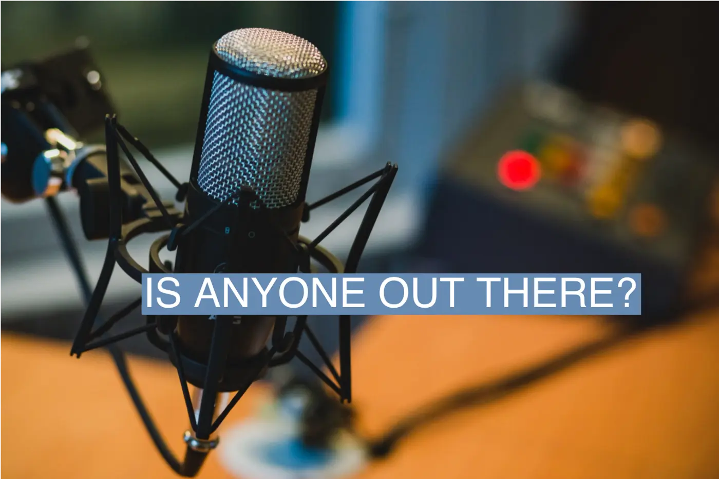 Image of a microphone used in podcasting overlaid with the text Is anyone out there