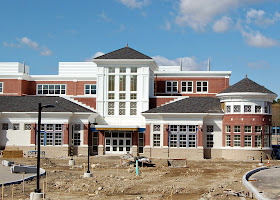 photo of new FHS building main entrance (white tower) and principal's office (round tower)