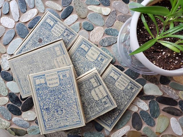 image of six books on a stone table top