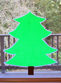 Sticky Kid-Sized Christmas Tree with reusable ornaments - you can decorate all season long!  From Fun at Home with Kids