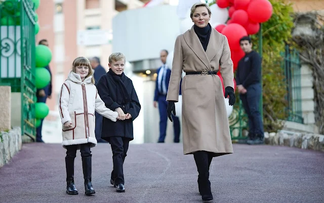 Princess Charlene wore a beige wool coat by Balenciaga. Princess Gabriella wore a faux shearling coat by Chloe Kids