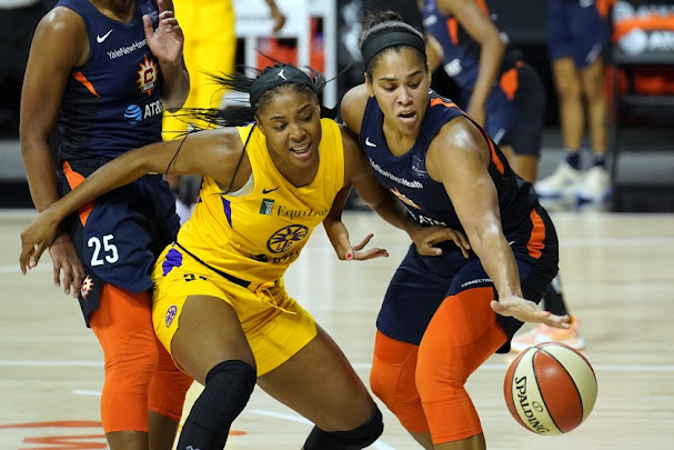 Sun center Brionna Jones (right) steals the ball from Sparks center Kristine Anigwe during the first half of Connecticut's second-round victory over Los Angeles.