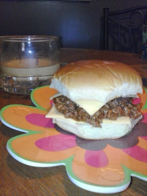 Sloppy joe with cheese on a hamburger bun.