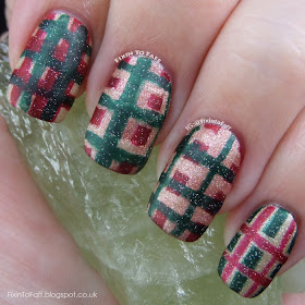 Tartan plaid nail art in Christmas colors red, green, and gold.
