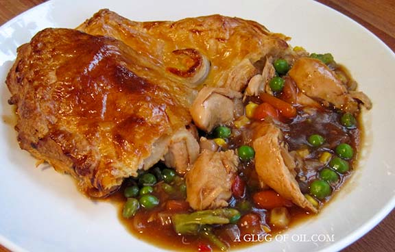 Chicken and vegetable pie with gravy.