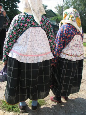 Women come for church service at the celebration of the Transfiguration, wearing traditional clothing with ponyova. Ryazan Oblast, August 2006.