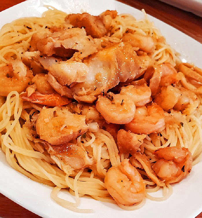 this is a dish of angel hair pasta with Venetian sauce with shrimp and calamari in it