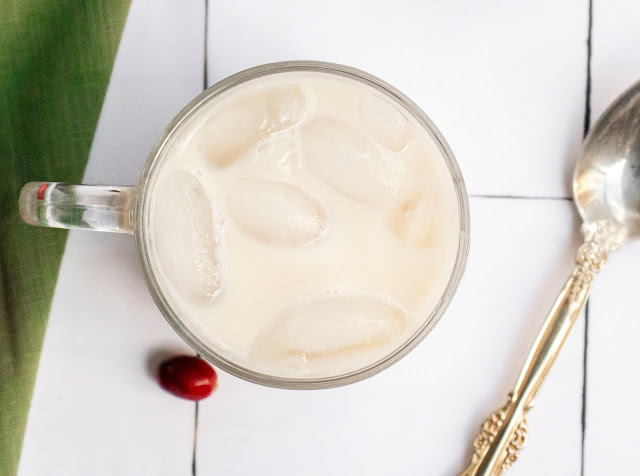 drink in a cup with a white and green background.