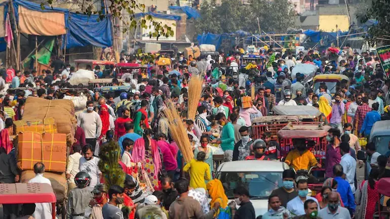 People flout social distancing norms at Delhi's Sadar Bazaar market. (Photo: PTI)