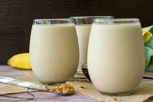 Three glasses of blended peanut punch ready to drink.