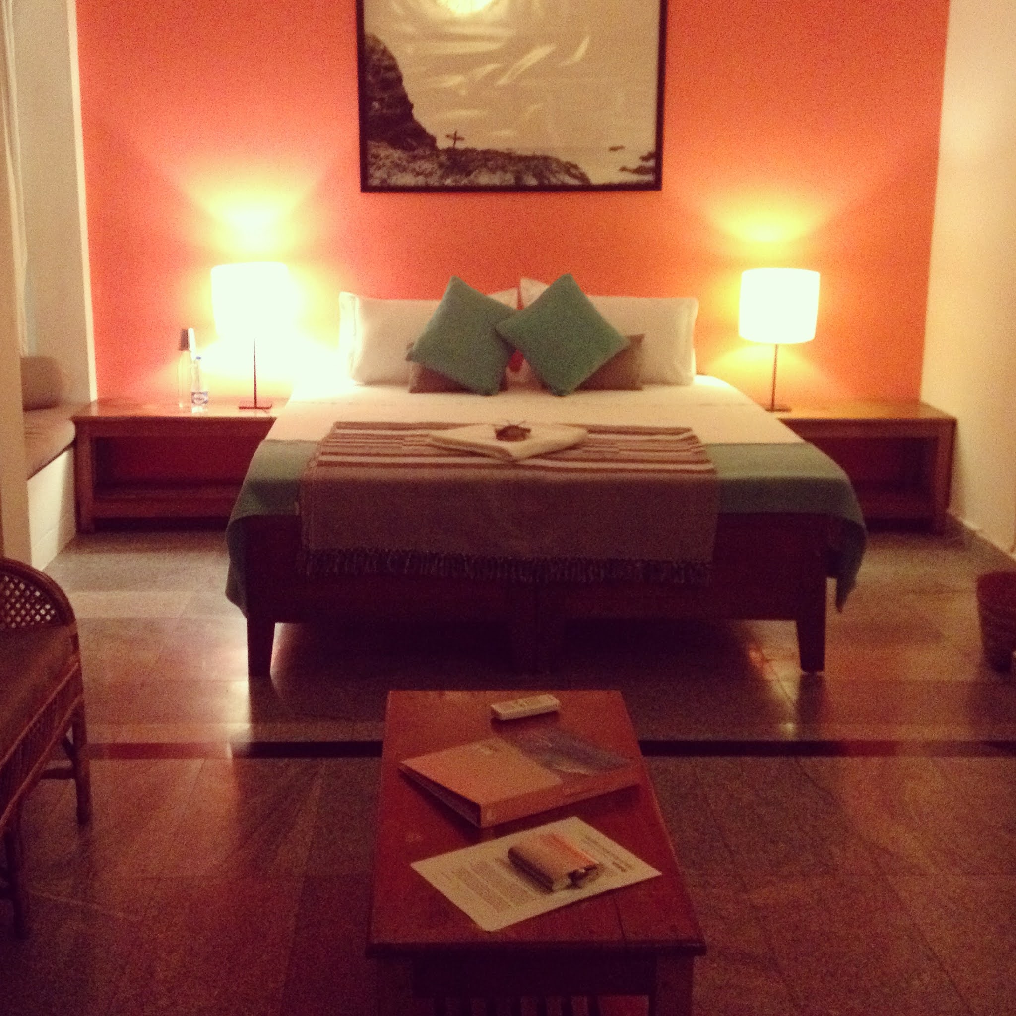 bed with orange wall and lamps in soul and surf varkala kerala india