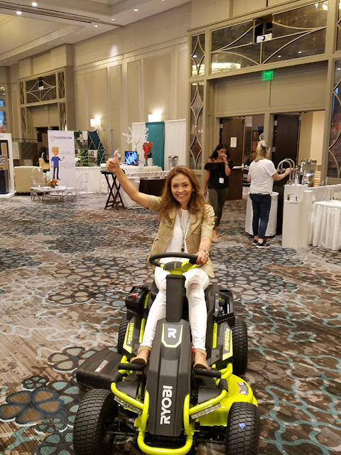 Cristina Garay riding the Ryobi Electric lawn mower during Haven conference