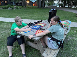 Youth and youth worker sitting at a picnic table