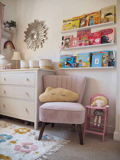 A pink and mustard yellow girls nursery bedroom, complete with cute accessories, colourful decor and homemade DIY touches. Including the IKEA Minnen bed, boho wall hanging, and IKEA hack dollhouse. Nursery inspiration and budget ideas.