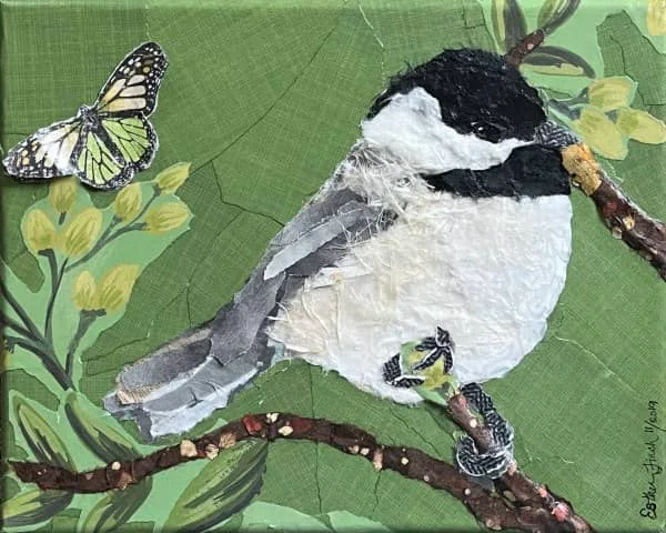 paper collage of black and white bird on branch with leaves and butterfly