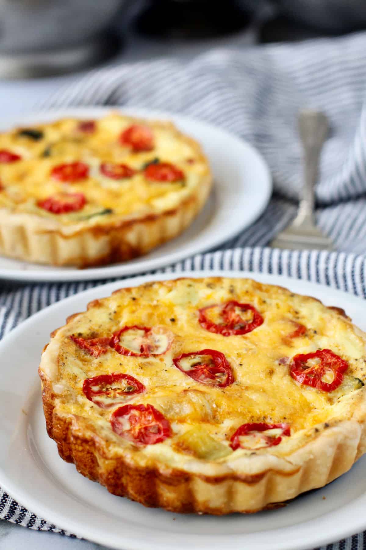 Vegetable and Cheddar Tarts on two plates.