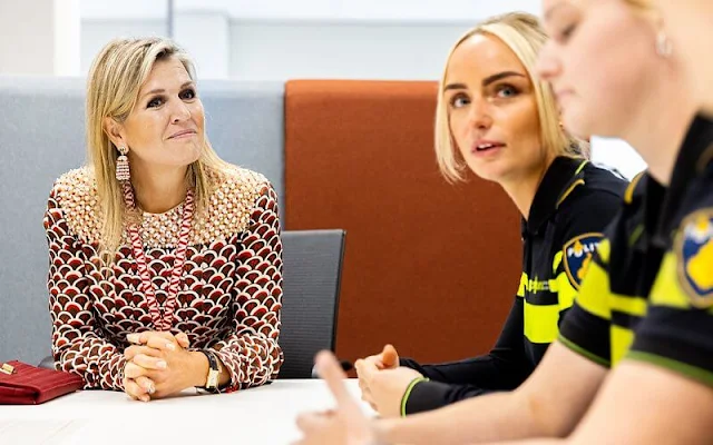 Queen Maxima visited the Roze in Blauw police force. Queen Maxima wore a scale-print silk twill midi dress by Valentino
