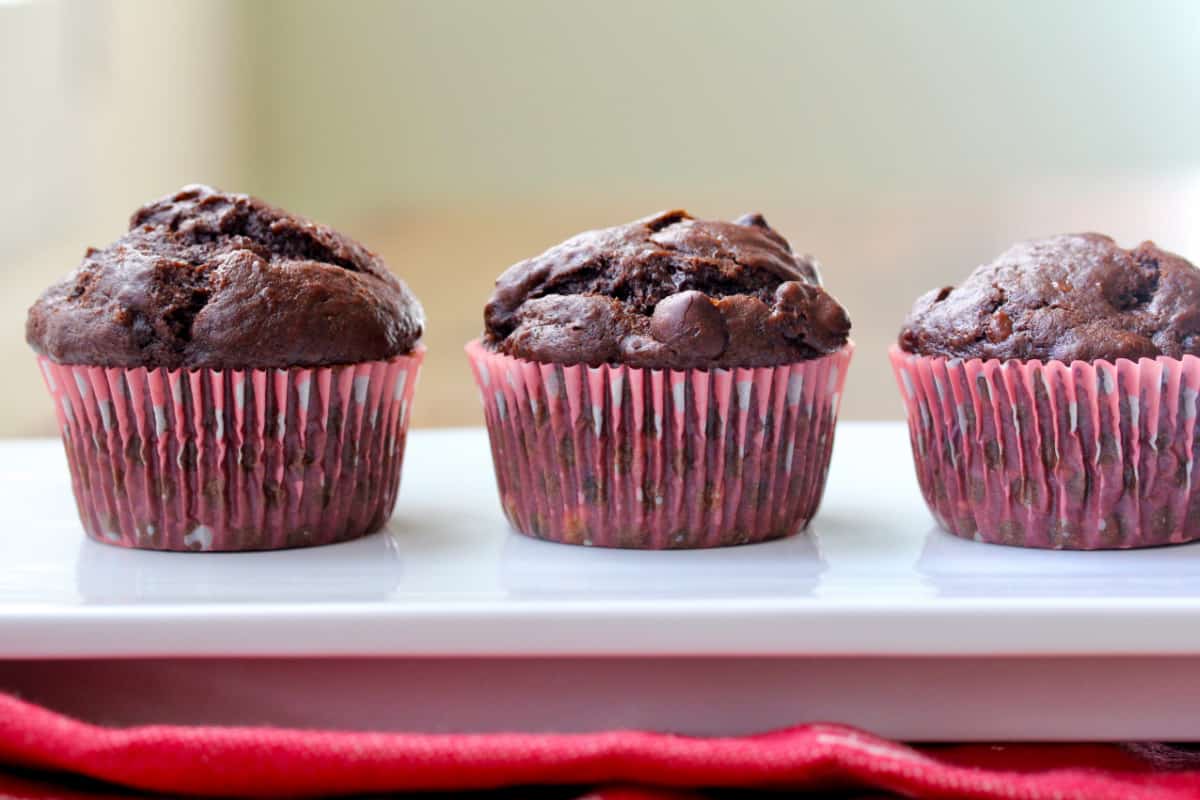 Three Double Chocolate Chip Banana Muffins in a row.