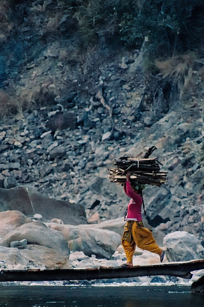Photo Stories: Daily Life: Woman with Firewood Over a Bridge