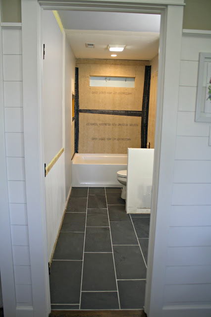 Bathroom with dark gray floor tile