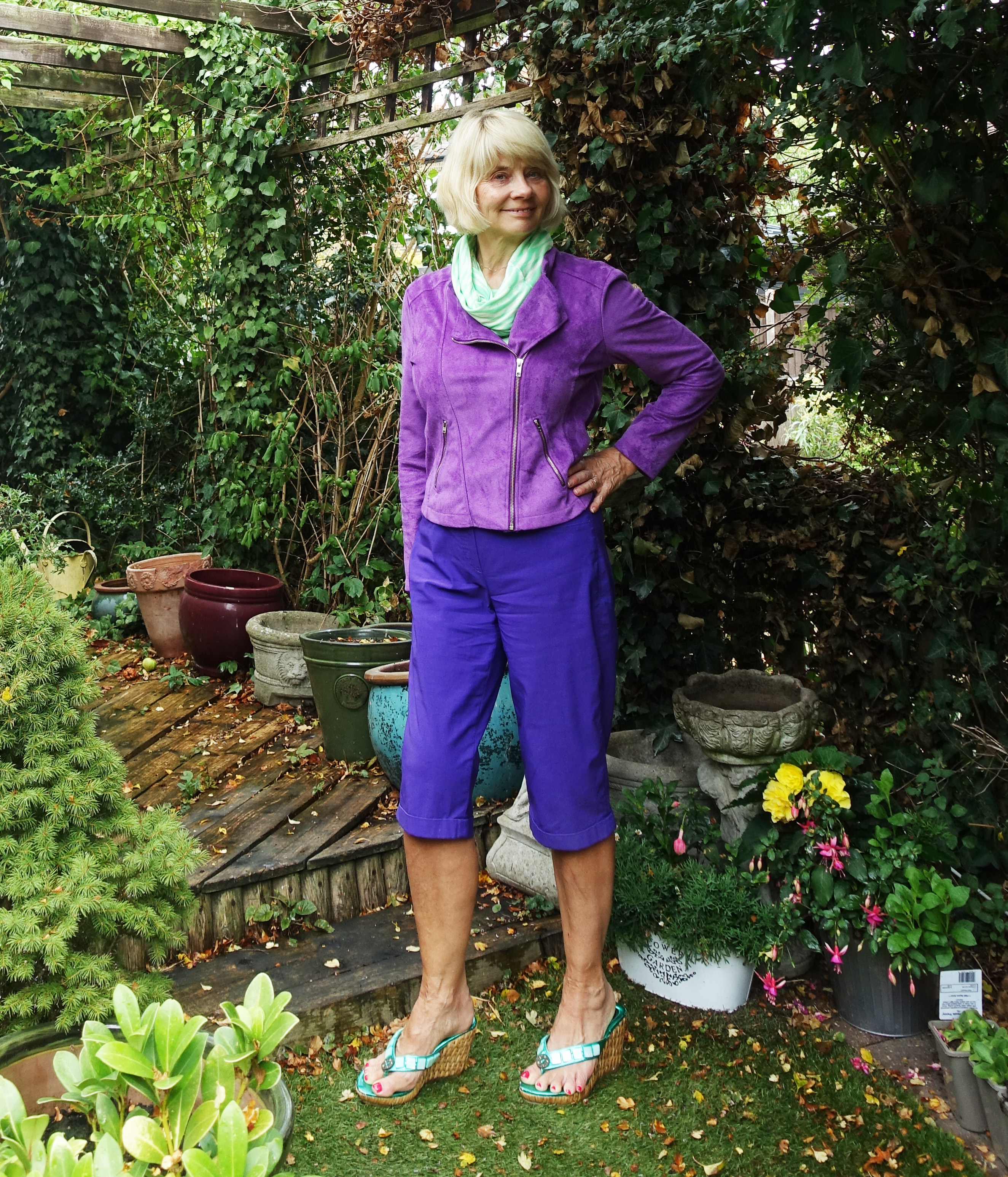 City shorts and a suede jacket and scarf are smart enough for business. Gail Hanlon from Is This Mutton in purple shorts from Robell, Bright Violet jacket and scarf from Kettlewell Colours.