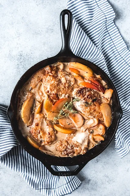 Finished pan of creamy apple cider chicken in a skillet.