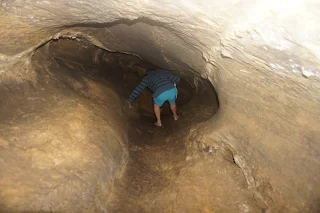 Me in a narrow cave tunnel