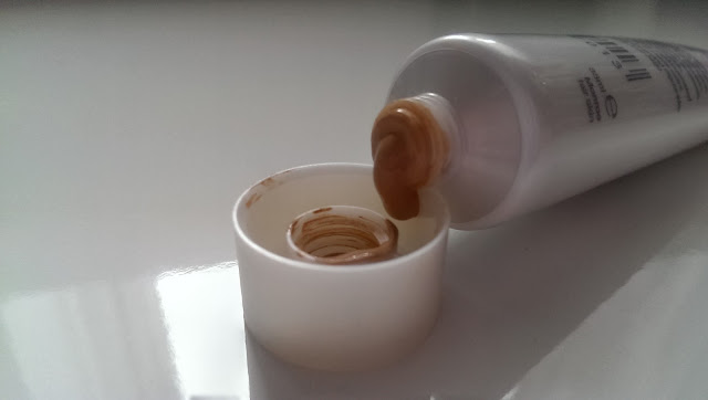 Helen E cosmetics stage foundation pouring out of the tube