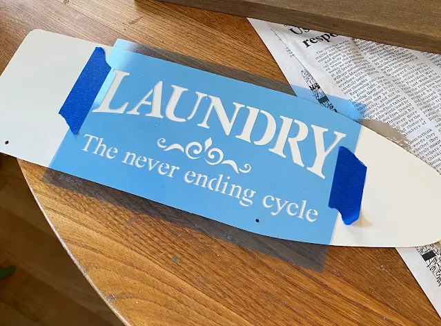 Photo of a laundry stencil on an ironing board shape