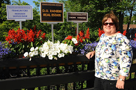 Beautification Chair Eileen Mason and the new Sponsors signs on the downtown bridge.