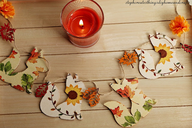 Completed fox garland displayed on twine with wooden leaves and faux floral