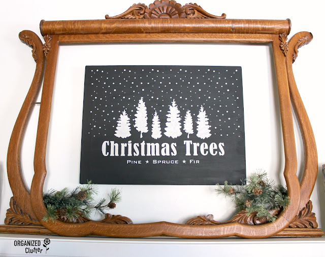 Photo of a free garage sale canvas painted and stenciled as a Christmas sign.