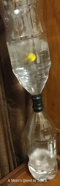 two soda bottles taped together to simulate a hurricane