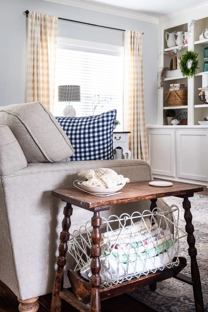 neutral sofa, blue checked pillow, antique side table