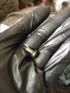 Piece of broken bolt after drilling