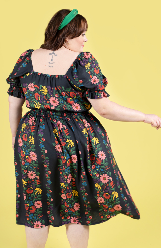 Plus size model wearing a floral shirred dress, made using Tilly and the Buttons Mabel sewing pattern